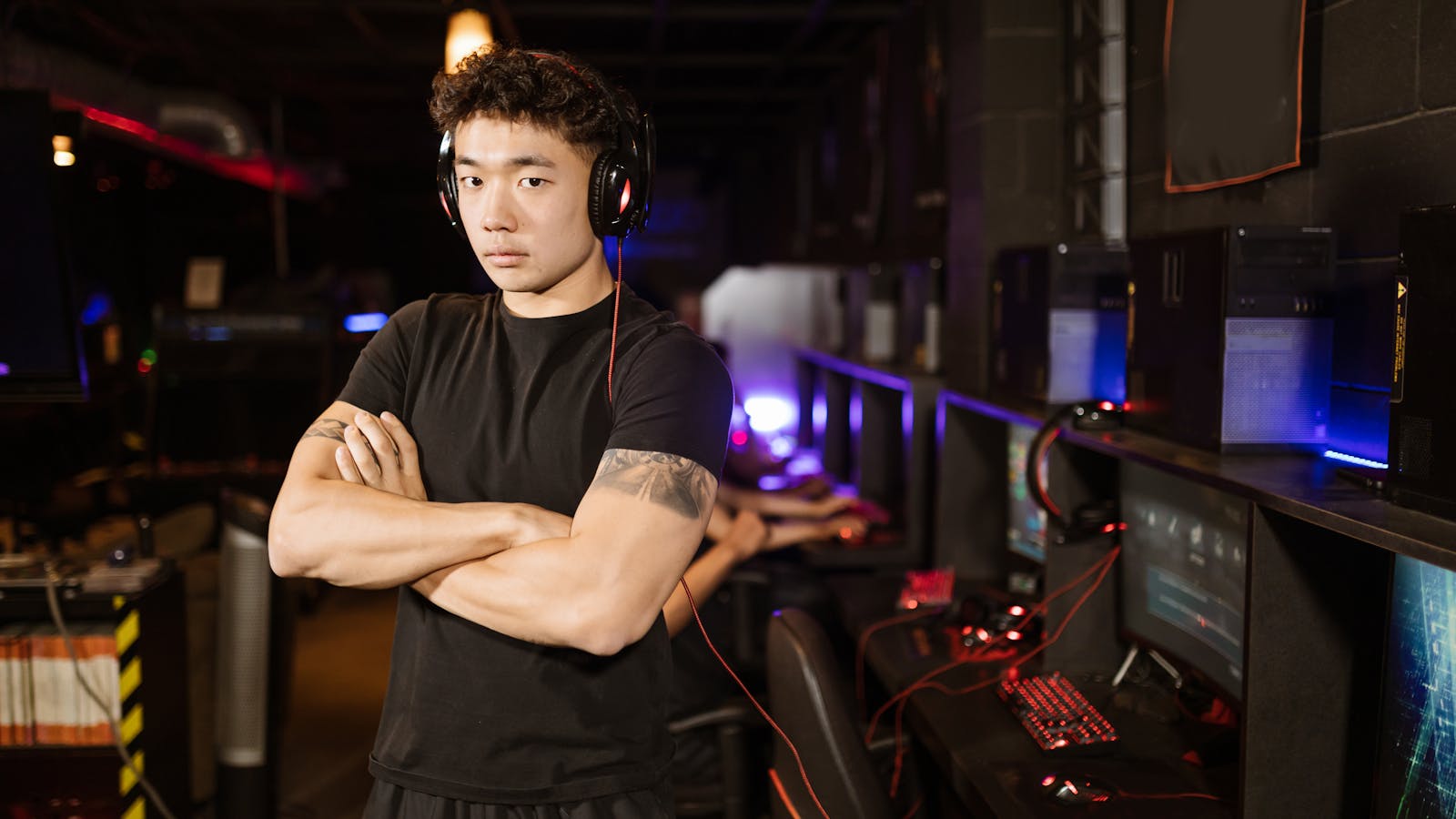 Gamer standing in a modern esports arena (placeholder)